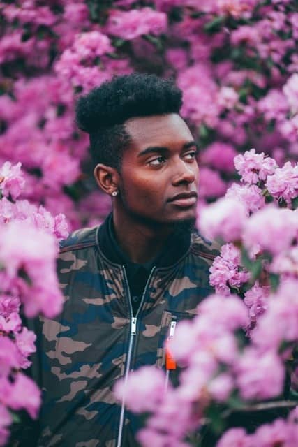 Black male in pink flowers thinking about meditation for black lives